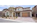 Charming two-story house featuring a brick driveway, modern garage, and stylish desert landscaping at 230 Carmel Sky St, Las Vegas, NV 89138
