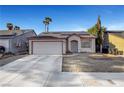 View of a single-story home with desert landscaping, a two-car garage, and solar panels at 2504 Soldier Creek Ct, Las Vegas, NV 89106