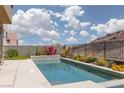 Gorgeous pool surrounded by lush landscaping, offering a serene and private backyard oasis at 292 Crimson Edge St, Henderson, NV 89012