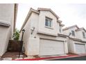 Well-maintained townhome features a red-tiled roof and an attached two-car garage at 3018 Sunrise Bay Ave, North Las Vegas, NV 89031