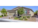 Attractive single-story house with a brick driveway, desert landscaping, and neutral-colored exterior at 3122 Berceto Ct, Henderson, NV 89044
