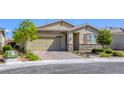 Single-story home featuring a brick driveway, desert landscaping, and a neutral color scheme at 3122 Berceto Ct, Henderson, NV 89044