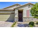 Inviting single-story home with stone detailing and a brick path leading to the front door at 3122 Berceto Ct, Henderson, NV 89044