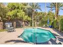 Inviting community pool area with lounge chairs, mature trees, and refreshing blue water for relaxing and recreation at 3135 S Mojave Rd # 146, Las Vegas, NV 89121