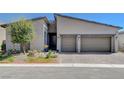 Modern home with a two-car garage, low-maintenance landscaping, and tasteful exterior lighting at 33 Reverie Heights Ave, Henderson, NV 89011