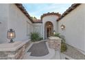 Home entrance featuring stone accents and an arched doorway with custom iron gate at 3540 Wisdom Ct, Las Vegas, NV 89120
