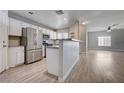 Modern kitchen featuring stainless steel appliances, bar seating, and bright, natural light at 4716 Cohiba Way, North Las Vegas, NV 89031