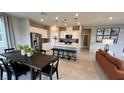 Open concept kitchen with stainless steel appliances, modern white cabinets, and large island with seating at 5151 Capucina St # Lot 1, Las Vegas, NV 89122