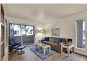 Cozy living room with hardwood floors, a sliding glass door, and comfortable furnishings at 5235 Caspian Springs St # 101, Las Vegas, NV 89120