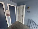 Unit 203 entryway with a modern security door, blue trim and a charming vintage-style lantern at 5320 Portavilla Ct # 203, Las Vegas, NV 89122