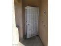 Close-up of condo's entrance door with metal security gate at 5750 E Hacienda Ave # 117, Las Vegas, NV 89122