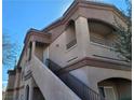 Exterior view of a condo building with stairs leading up to the entrance at 5750 E Hacienda Ave # 117, Las Vegas, NV 89122