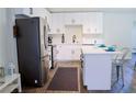 Modern kitchen with stainless steel appliances and white cabinetry at 6198 Pinewood Ave, Las Vegas, NV 89103