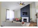 Bright living room with modern fireplace, grey sofa, and elegant accents at 6198 Pinewood Ave, Las Vegas, NV 89103