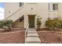 Exterior shot of a building featuring stairs and landscaping with red rock at 698 S Racetrack Rd # 114, Henderson, NV 89015