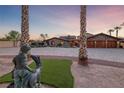 Charming home with manicured lawn and stone accents, complemented by mature palm trees at 728 N Kiel St, Henderson, NV 89015
