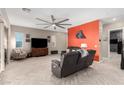 Spacious living room with contemporary furniture, a ceiling fan and light wood look flooring at 731 Glowing Horizon St, Henderson, NV 89052