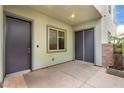 Covered patio with dual entry doors, a window and a stone accent wall with water feature at 731 Glowing Horizon St, Henderson, NV 89052