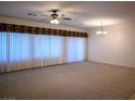 Spacious living room with neutral carpet and large windows for ample light at 7668 Broadwing Dr, North Las Vegas, NV 89084