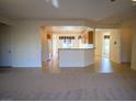 Open living space with a view of the kitchen featuring a breakfast bar at 7668 Broadwing Dr, North Las Vegas, NV 89084