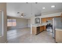 Open concept kitchen with stainless steel appliances and light wood cabinetry at 8028 Hurricane Cove Ct, Las Vegas, NV 89129
