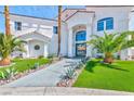 Elegant front entrance with manicured landscaping and a modern glass door at 8133 Desert Jewel Cir, Las Vegas, NV 89128