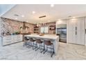 Spacious kitchen featuring a large island, stainless steel appliances, and custom backsplash at 8133 Desert Jewel Cir, Las Vegas, NV 89128