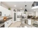 Beautiful kitchen features white cabinets, granite countertops, stainless steel appliances, and a view into the dining area at 8316 Gold River Ct, Las Vegas, NV 89113