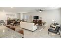 Inviting living room and dining area featuring stylish decor, comfortable seating, and ample natural light at 8316 Gold River Ct, Las Vegas, NV 89113