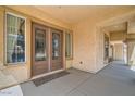 Inviting entryway featuring double doors with glass inserts, complemented by a covered porch and neutral tones at 8431 Jeremiah Grove St, Las Vegas, NV 89123