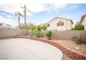 Spacious backyard features a large concrete patio, retaining wall, and desert landscaping for outdoor enjoyment at 8564 Lost Gold Ave, Las Vegas, NV 89129