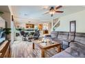 Cozy living room featuring hardwood floors, a comfortable sofa, and an open layout at 890 Socorro Song Ln, Henderson, NV 89052