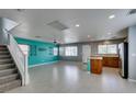 Spacious living room with tile flooring, open layout, and stairs to second floor at 9476 Milkweed Canyon Ave, Las Vegas, NV 89166