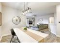 Open concept living space with modern light fixtures, inviting decor and stylish flooring at 9535 Vega Carpio Ave, Las Vegas, NV 89178