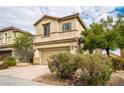 Inviting two-story home with a two-car garage, desert landscaping, and a neutral stucco facade at 9750 Maple Sugar Leaf Pl, Las Vegas, NV 89148