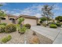 Charming single-story home featuring a two-car garage and desert landscaping with a tiled roof at 10241 Premia Pl, Las Vegas, NV 89135