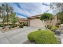 Charming single-story home featuring a two-car garage, desert landscaping, and a convenient mailbox at 10241 Premia Pl, Las Vegas, NV 89135