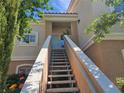Inviting condo entrance with outdoor stairs and covered porch offering curb appeal at 10500 Pine Pointe Ave # 206, Las Vegas, NV 89144