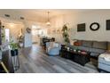 Inviting living room boasts new flooring and connects to the kitchen, ideal for modern living at 10500 Pine Pointe Ave # 206, Las Vegas, NV 89144