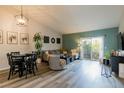 Bright, modern living room featuring new flooring and a sliding glass door leading to a balcony at 10500 Pine Pointe Ave # 206, Las Vegas, NV 89144