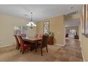 Inviting dining room featuring a large wooden table, elegant chandelier, and neutral color scheme at 10858 Morning Frost St, Las Vegas, NV 89179