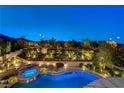 Elevated view of the pool and backyard area with a firepit and lush landscaping at 12122 High Country Ln, Las Vegas, NV 89138