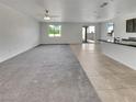 Open-concept living space featuring gray carpet and tile flooring, perfect for modern living at 138 Scarlett View Ave, North Las Vegas, NV 89031