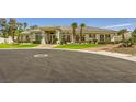 Well-maintained home with lush landscaping, mature palm trees, and circular driveway at 1508 Ten Palms Ct, Las Vegas, NV 89117