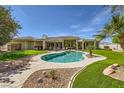 Backyard view featuring a sparkling private pool and landscaped patio area perfect for outdoor entertaining at 1508 Ten Palms Ct, Las Vegas, NV 89117