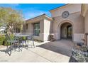 Home featuring a front patio with outdoor seating, stylish architecture, and a water feature at 1725 Cypress Manor Dr, Henderson, NV 89012