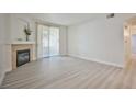 Bright, open living room features a fireplace, neutral paint, and sliding glass door to the outside at 1830 N Buffalo Dr # 1091, Las Vegas, NV 89128