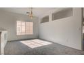 Sunlit room with plush gray carpet and a large window offering a bright, inviting space at 1890 Bova Matrina Ct, Las Vegas, NV 89123