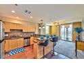 Well-lit kitchen features stainless steel appliances, granite counters, and breakfast bar at 2405 W Serene Ave # 703, Las Vegas, NV 89123