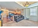 Open living room and kitchen area with modern lighting fixtures and neutral decor at 2405 W Serene Ave # 703, Las Vegas, NV 89123